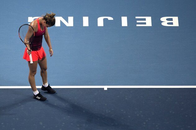 Simona Halep of Romania reacts after losing a point to Lara Arruabarrena-Vecino of Spain during their first round match of the China Open tennis tournament at the National Tennis Stadium in Beijing, Sunday, Oct. 4, 2015. (AP Photo/Andy Wong)