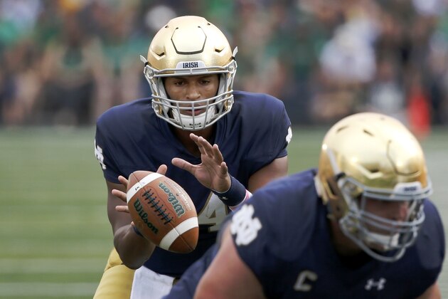 Notre Dame quarterback DeShone Kizer takes the snap in the shotgun formation during the first half of an NCAA college football game against Massachusetts Saturday, Sept. 26, 2015, in South Bend, Ind. (AP Photo/Charles Rex Arbogast)