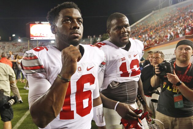 Ohio State quarterback J.T. Barrett (16) and teammate quarterback Cardale Jones (12) celebrate winning over Virginia Tech after an NCAA college football game in Blacksburg, Va., Monday, Sept. 7, 2015.  Ohio State won the game 42-24.  (AP Photo/Steve Helber)