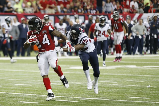 Atlanta Falcons running back Devonta Freeman (24) heads to the end zone for a touchdown against Houston Texans free safety Rahim Moore (26) during the first half of an NFL football game, Sunday, Oct. 4, 2015, in Atlanta. (AP Photo/John Bazemore)