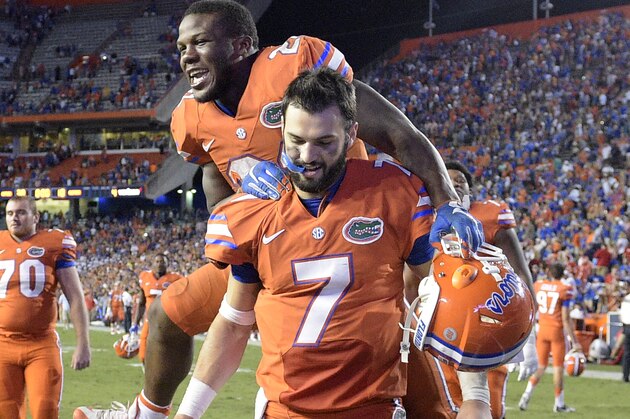 Florida running back Kelvin Taylor celebrates by jumping on quarterback Will Grier (7) after their 38-10 win over Mississippi in an NCAA college football game Saturday, Oct. 3, 2015, in Gainesville, Fla. (AP Photo/Phelan M. Ebenhack)