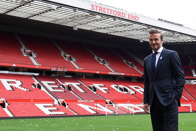 Former Manchester United and England footballer David Beckham poses on the pitch at Old Trafford in Manchester, north west England on October 6, 2015 ahead of a charity football match in aid of UNICEF. Beckham will lead the Great Britain and Ireland team against a Rest of the World team led by Zinedine Zidane at Old Trafford on November 14.
 AFP PHOTO/PAUL ELLIS        (Photo credit should read PAUL ELLIS/AFP/Getty Images)