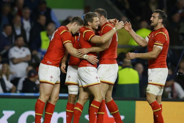 Wales players celebrate their 25-28 win after the Rugby World Cup Pool A match between England and Wales at Twickenham Stadium, London, Saturday, Sept. 26, 2015. (AP Photo/Kirsty Wigglesworth)
