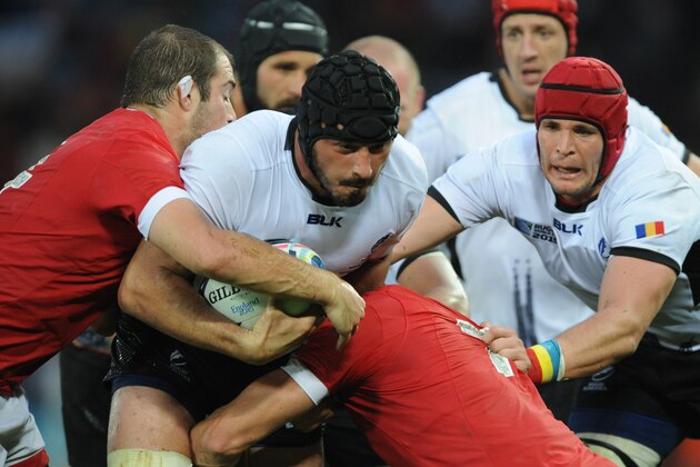 Romania's Valentin Poparlan is tackled by Canada's Brett Beukeboom, left, and John Moonlight during the Rugby World Cup Pool D match between Canada and Romania at the Leicester City Stadium, Leicester, England, Tuesday, Oct. 6, 2015. (AP Photo/Rui Vieira)