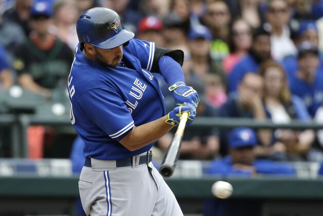 Toronto Blue Jays' Chris Colabello singles in a pair of runs against the Seattle Mariners in the ninth inning of a baseball game Saturday, July 25, 2015, in Seattle. (AP Photo/Elaine Thompson)