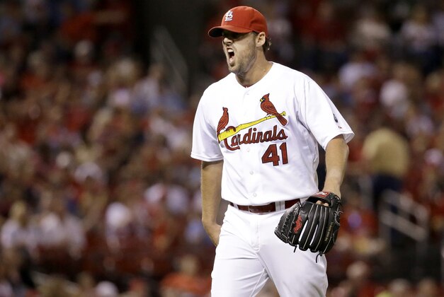 St. Louis Cardinals starting pitcher John Lackey yells as he walks off the field after getting Cincinnati Reds' Tucker Barnhart to line out to end the top of the seventh inning of a baseball game on Tuesday, Sept. 22, 2015, in St. Louis. (AP Photo/Jeff Roberson)
