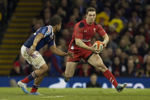 Wales' George North, right, keeps the ball from France's Wesley Fofana during their Six Nations rugby union international match at the Millennium Stadium, Cardiff, Wales, Friday, Feb. 21, 2014. (AP Photo/Jon Super)