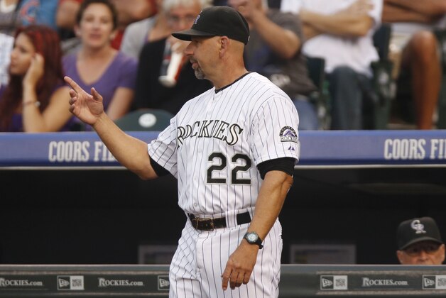 Colorado Rockies manager Walt Weiss points to the bullpen to call in relief pitcher Justin Miller to replace starting pitcher Chris Rusin who gave up a double to New York Mets' Curtis Granderson  in the third inning of a baseball game Saturday, Aug. 22, 2015, in Denver. (AP Photo/David Zalubowski)