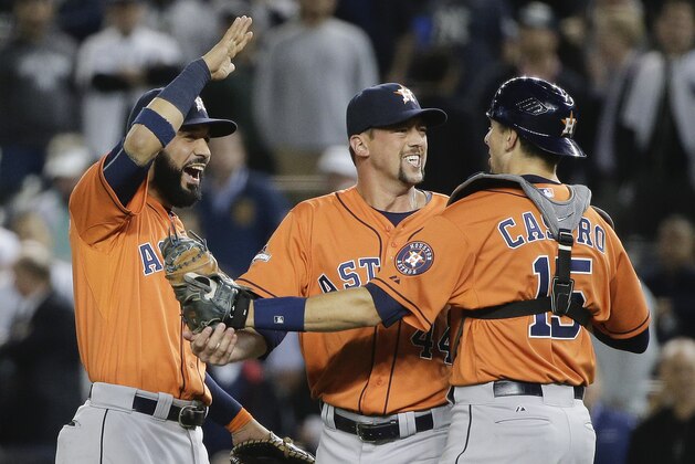 Houston Astros first baseman Chris Carter, left, Luke Gregerson, center, and Jason Castro (15) celebrate after the Astros defeated the New York Yankees 3-0 in the American League wild card baseball game, Tuesday, Oct. 6, 2015, in New York. (AP Photo/Julie Jacobson)