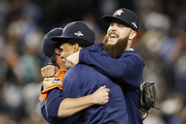 Houston Astros relief pitcher Luke Gregerson, left, Carlos Gomez, and Dallas Keucel celebrate after the Astros shutout the New York Yankees 3-0 in the American League wild card baseball game at Yankee Stadium in New York, Tuesday, Oct. 6, 2015.  (AP Photo/Kathy Willens)