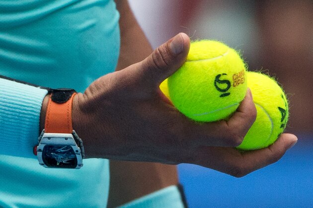 Rafael Nadal of Spain holds the balls as he prepares to serve against Wu Di of China during their first round men's singles match of the China Open tennis tournament at the National Tennis Stadium in Beijing, Tuesday, Oct. 6, 2015. (AP Photo/Andy Wong)