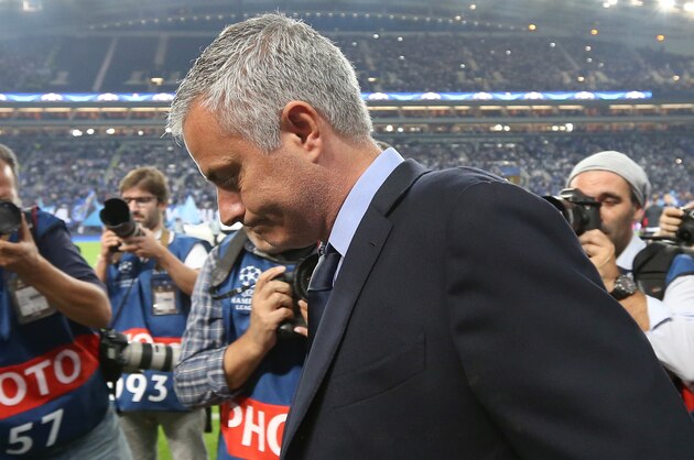 Photographers swarm Chelsea manager Jose Mourinho on the sidelines during the Champions League group G soccer match between FC Porto and Chelsea FC at the Dragao stadium in Porto, Portugal, Tuesday, Sept. 29, 2015.  Porto won 2-1. (AP Photo/Steven Governo)