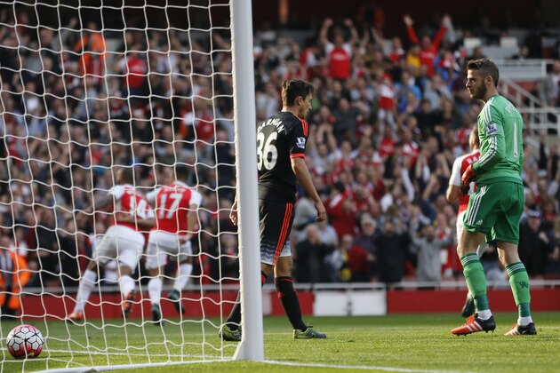 Manchester United's goalkeeper David de Gea, right looks back at the ball in the net after conceding Arsenal's first goal during the English Premier League soccer match between Arsenal and Manchester United at Emirates stadium in London, Sunday, Oct. 4, 2015.(AP Photo/Frank Augstein)
