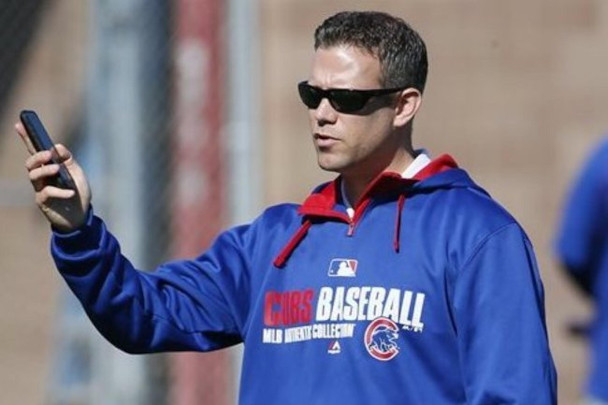 FILE - In this Feb. 25, 2015, file photo, Chicago Cubs president of baseball operations Theo Epstein talks on his phone during a spring training baseball practice in Mesa, Ariz. Epstein's answer to the question that's haunted Cubs fans for a century-and-counting hasn't changed. It's the same one he gave four years ago, when Epstein was introduced as the franchise's latest savior to great fanfare and pleaded for patience: He has no idea. Neither does anyone else.(AP Photo/Matt York, File) FILE - In this Feb. 25, 2015, file photo, Chicago Cubs president of baseball operations Theo Epstein talks on his phone during a spring training baseball practice in Mesa, Ariz. Epstein's answer to the question that's haunted Cubs fans for a century-and-counting hasn't changed. It's the same one he gave four years ago, when Epstein was introduced as the franchise's latest savior to great fanfare and pleaded for patience: He has no idea. Neither does anyone else.(AP Photo/Matt York, File)