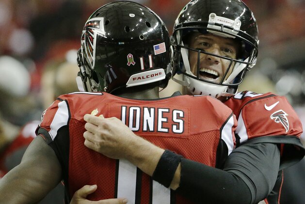 Atlanta Falcons quarterback Matt Ryan (2) embraces Atlanta Falcons wide receiver Julio Jones (11) after Atlanta Falcons running back Devonta Freeman scored a touchdown against the Houston Texans during the second half of an NFL football game, Sunday, Oct. 4, 2015, in Atlanta. (AP Photo/David Goldman)