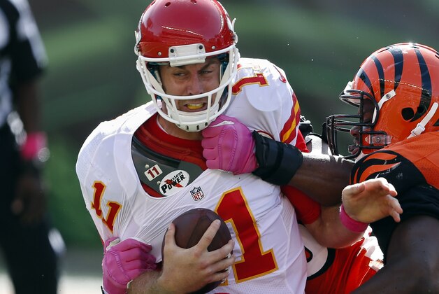 Kansas City Chiefs quarterback Alex Smith (11) is sacked by Cincinnati Bengals defensive end Carlos Dunlap, behind, with assistance from defensive tackle Geno Atkins (97) in the second half of an NFL football game, Sunday, Oct. 4, 2015, in Cincinnati. (AP Photo/Gary Landers)