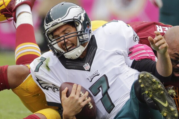 Washington Redskins defensive end Jason Hatcher (97) looses his helmut during a sack of Philadelphia Eagles quarterback Sam Bradford (7) during the first half of an NFL football game in Landover, Md., Sunday, Oct. 4, 2015. (AP Photo/Mark Tenally)