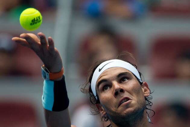 Rafael Nadal of Spain tosses the ball as he serves against Wu Di of China during their first round men's singles match of the China Open tennis tournament at the National Tennis Stadium in Beijing, Tuesday, Oct. 6, 2015. (AP Photo/Andy Wong)