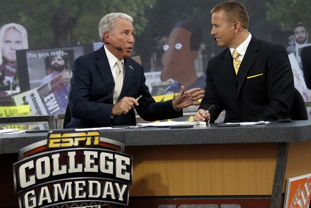 ESPN College GameDay hosts Lee Corso, left, and Kirk Herbstreit confer during the telecast from The Junction prior to Mississippi State playing Auburn in an NCAA college football game in Starkville, Miss., Saturday, Oct 11, 2014. No.3 Mississippi State beat No. 2 Auburn 38-23. (AP Photo/Rogelio V. Solis)
