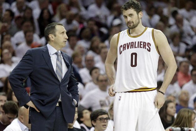 Cleveland Cavaliers head coach David Blatt, left, talks with Cleveland Cavaliers' Kevin Love (0) during the first round NBA playoff basketball game Sunday, April 19, 2015, in Cleveland. (AP Photo/Mark Duncan)