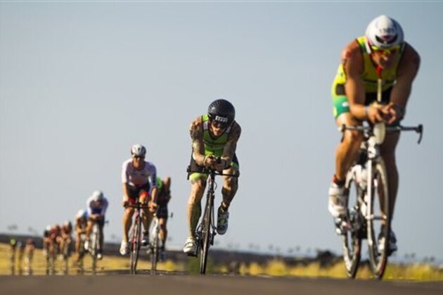 IMAGE DISTRIBUTED FOR IRONMAN - In this photo provided by the 2014 IRONMAN World Championship presented by GoPro, age group racers hit the road during the 112-mi bike race during the 2014 IRONMAN World Championship presented by GoPro on Saturday, Oct. 11, 2014 in Kailua Kona, Hawaii. (Marco Garcia/AP Images for IRONMAN ) IMAGE DISTRIBUTED FOR IRONMAN - In this photo provided by the 2014 IRONMAN World Championship presented by GoPro, age group racers hit the road during the 112-mi bike race during the 2014 IRONMAN World Championship presented by GoPro on Saturday, Oct. 11, 2014 in Kailua Kona, Hawaii. (Marco Garcia/AP Images for IRONMAN )