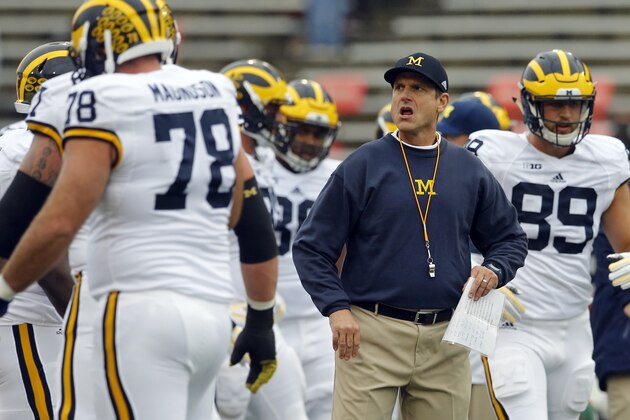 Michigan head coach Jim Harbaugh watches his players warm up before an NCAA college football game against Maryland, Saturday, Oct. 3, 2015, in College Park, Md. (AP Photo/Patrick Semansky)