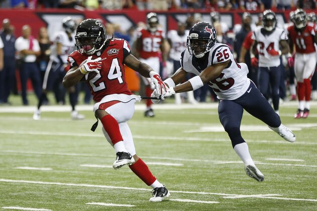 Atlanta Falcons running back Devonta Freeman (24) heads to the end zone for a touchdown against Houston Texans free safety Rahim Moore (26) during the first half of an NFL football game, Sunday, Oct. 4, 2015, in Atlanta. (AP Photo/John Bazemore)