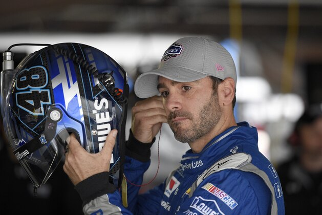 Jimmie Johnson gets ready before practice for the NASCAR Sprint Cup series auto race, Saturday, Oct. 3, 2015, at Dover International Speedway in Dover, Del. (AP Photo/Nick Wass)