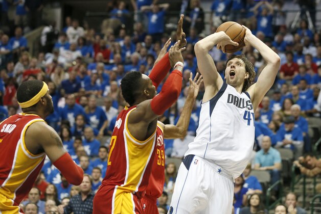 Houston Rockets' Josh Smith, left, and Dwight Howard, center, defend as Dallas Mavericks' Dirk Nowitzki (41) of Germany attempts a shot during Game 4 in an NBA basketball first-round playoff series Sunday April 26, 2015, in Dallas. (AP Photo/Tony Gutierrez)