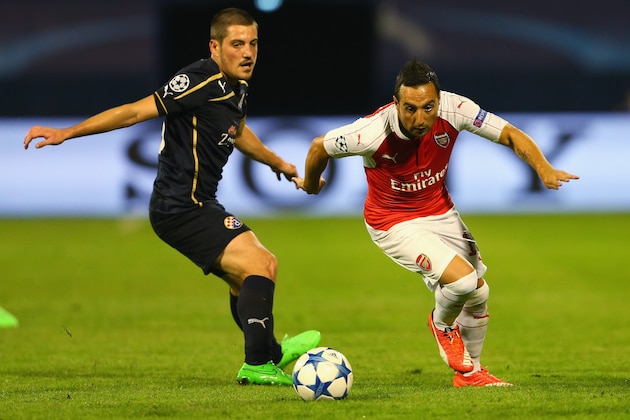 ZAGREB, CROATIA - SEPTEMBER 16:  Santi Cazorla of Arsenal goes past Arijan Ademi of Dinamo Zagreb during the UEFA Champions League Group F match between Dinamo Zagreb and Arsenal at Maksimir Stadium on September 16, 2015 in Zagreb, Croatia.  (Photo by Alexander Hassenstein/Getty Images)