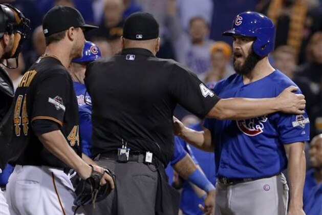Chicago Cubs starting pitcher Jake Arrieta, right, speaks to Pittsburgh Pirates relief pitcher Tony Watson, left, after he was hit by a Watson pitch in the seventh inning of the National League wild card baseball game, Wednesday, Oct. 7, 2015, in Pittsburgh. (AP Photo/Gene J. Puskar)