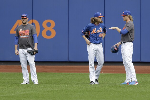 New York Mets pitchers Matt Harvey, left, Jacob deGrom, center, and Noah Syndergaard stand in the outfield during a workout at Citi Field, Wednesday, Oct. 7, 2015 in New York. The Mets will play the Los Angeles Dodgers in a National League Division Series starting Friday in Los Angeles.(AP Photo/Seth Wenig) New York Mets pitchers Matt Harvey, left, Jacob deGrom, center, and Noah Syndergaard stand in the outfield during a workout at Citi Field, Wednesday, Oct. 7, 2015 in New York. The Mets will play the Los Angeles Dodgers in a National League Division Series starting Friday in Los Angeles.(AP Photo/Seth Wenig)