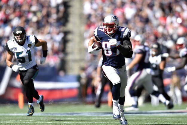 Sep 27, 2015; Foxborough, MA, USA; New England Patriots tight end Rob Gronkowski (87) carries after the catch in the first quarter against the Jacksonville Jaguars at Gillette Stadium. Mandatory Credit: James Lang-USA TODAY Sports