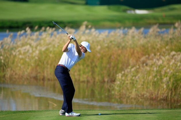 INCHEON CITY, SOUTH KOREA - OCTOBER 08:  Jordan Spieth of the United States Team plays from the drop-zone on the 11th hole after his partner Dustin Johnson had driven into the water off the tee during the Thursday foursomes matches at The Presidents Cup at Jack Nicklaus Golf Club Korea on October 8, 2015 in Songdo IBD, Incheon City, South Korea  (Photo by David Cannon/Getty Images)