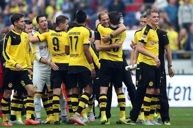 Dortmund's head coach Thomas Tuchel (4thR) celebrates with team mates after the German first division Bundesliga football match Hannover 96 v Borussia Dortmund, in Hannover, on September 12, 2015.  AFP PHOTO /  RONNY HARTMANN

RESTRICTIONS: DURING MATCH TIME: DFL RULES TO LIMIT THE ONLINE USAGE TO 15 PICTURES PER MATCH AND FORBID IMAGE SEQUENCES TO SIMULATE VIDEO. 
== RESTRICTED TO EDITORIAL USE ==
FOR FURTHER QUERIES PLEASE CONTACT DFL DIRECTLY AT + 49 69 650050.        (Photo credit should read RONNY HARTMANN/AFP/Getty Images)