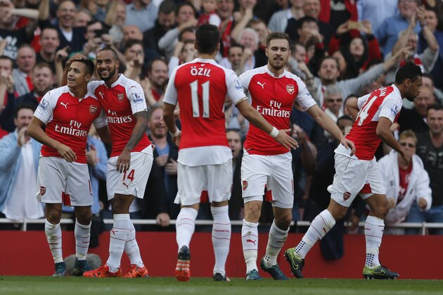 Arsenal's Alexis Sanchez, left celebrates with teammates after scoring his second goal of the game during the English Premier League soccer match between Arsenal and Manchester United at Emirates stadium in London, Sunday, Oct. 4, 2015.(AP Photo/Frank Augstein)