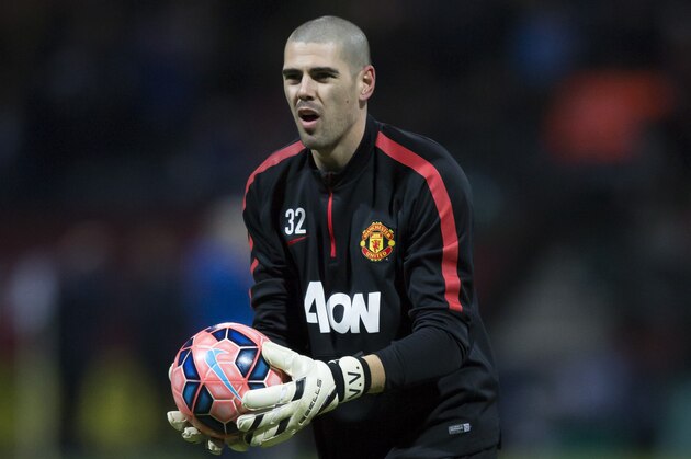 Manchester United's substitute goalkeeper Victor Valdes warms up before the English FA Cup Fifth Round soccer match between Preston and Manchester United at Deepdale Stadium in Preston, England, Monday, Feb. 16, 2015.  (AP Photo/Jon Super)