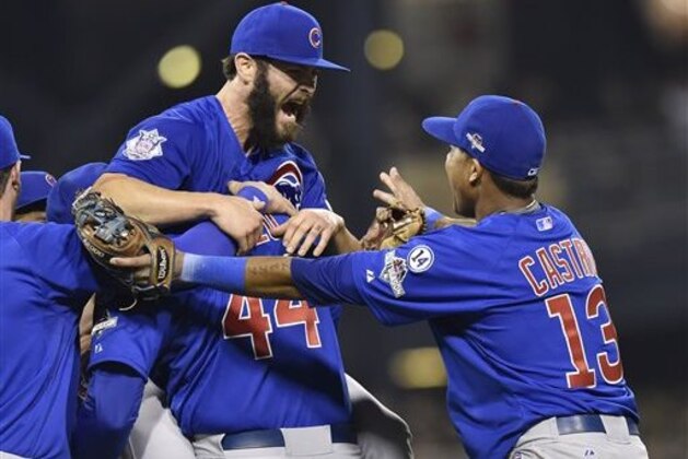 Chicago Cubs first baseman Anthony Rizzo, (44), holds Chicago Cubs starting pitcher Jake Arrieta as shortstop Starlin Castro (13) joins in the celebration after they defeated the Pittsburgh Pirates in the National League wild card baseball game 4-0, Wednesday, Oct. 7, 2015, in Pittsburgh. The Cubs advance to play the St. Louis Cardinals in the National League Division Series. (AP Photo/Don Wright)