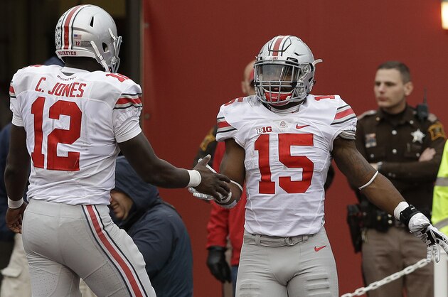 Ohio State's Ezekiel Elliott (15) celebrates with Cardale Jones (12) after Elliott ran 55 yards for a touchdown during the second half of an NCAA college football game  against Indiana, Saturday, Oct. 3, 2015 in Bloomington, Ind. (AP Photo/Darron Cummings)