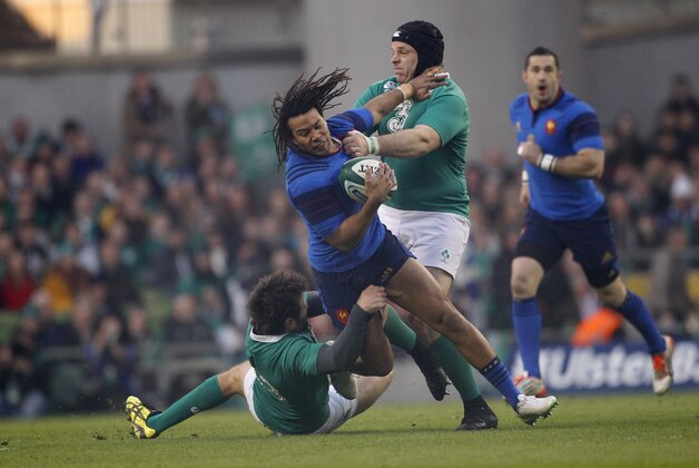 France's Teddy Thomas, center, is tackled by Ireland's Mike Ross, right, and Jared Payne, left, during their rugby union 6 nations match at the Aviva  stadium, Dublin, Ireland, Saturday, Feb. 14, 2015.  (AP Photo/Peter Morrison)