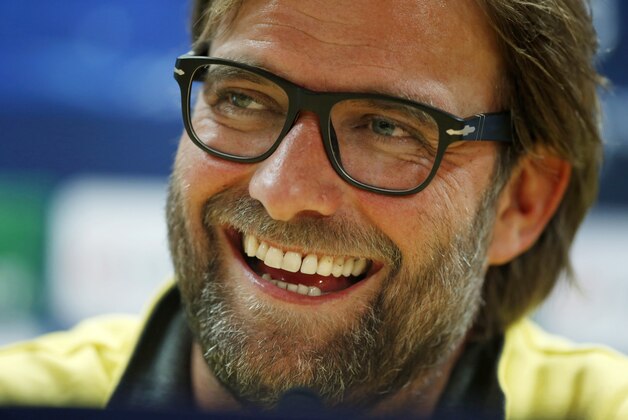 Borussia Dortmund's manager Jurgen Klopp laughs during a news conference at Arsenal's Emirates Stadium in London, England, Monday, Oct. 21, 2013. Arsenal are due to play Borussia Dortmund in a Champions League Group F soccer match in London on Tuesday. (AP Photo/Matt Dunham)