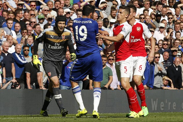 Arsenal's Gabriel, No 5, reacts and puts his arms onto Chelsea's Diego Costa, No 19, during the English Premier League soccer match between Chelsea and Arsenal at Stamford Bridge stadium in London, Saturday, Sept. 19, 2015. Both players were show a yellow card for the incident, with Gabriel being sent off for a further clash between the two player- Chelsea went onto win the game 2-0.(AP Photo/Alastair Grant)