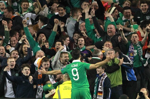 Ireland's Shane Long celebrates with fans after scoring the opening goal during the Euro 2016 group D qualifying soccer match between Ireland and Germany in Dublin, Ireland, Thursday, Oct. 8, 2015. (AP Photo/Peter Morrison)