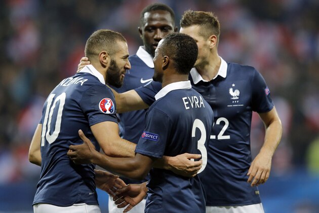 France's forward Karim Benzema (L) celebrates with teammates after scoring a goal during the friendly football match between France and Armenia on October 8, 2015 at the Allianz Riviera stadium in Nice, southeastern France. AFP PHOTO / VALERY HACHE        (Photo credit should read VALERY HACHE/AFP/Getty Images)