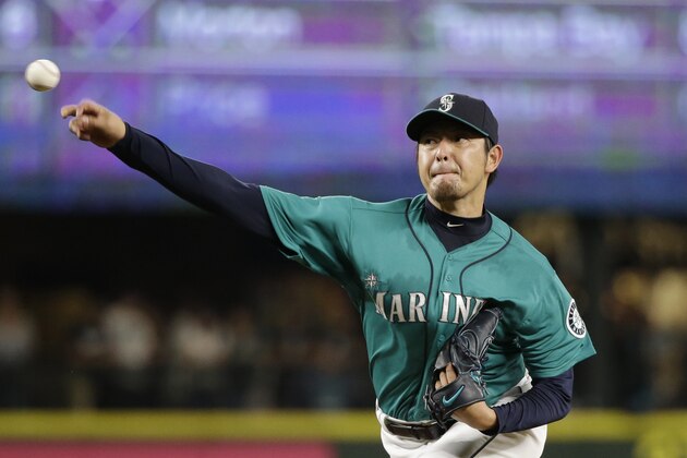 Seattle Mariners starting pitcher Hisashi Iwakuma throws against the Colorado Rockies in a baseball game Friday, Sept. 11, 2015, in Seattle. (AP Photo/Elaine Thompson)