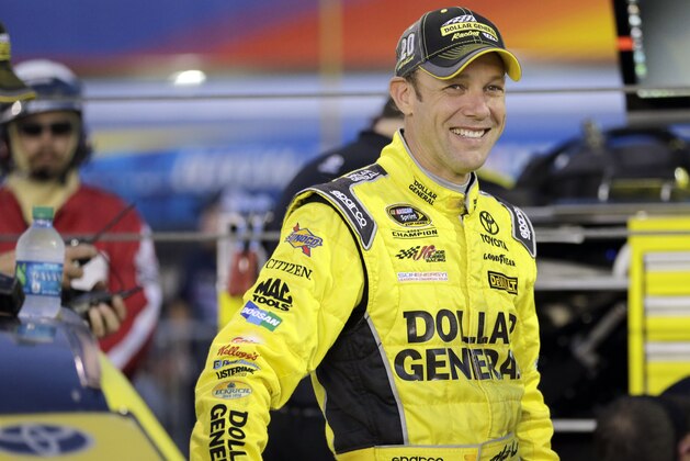 Matt Kenseth waits by his car before qualifying for the NASCAR Sprint Cup series auto race at Charlotte Motor Speedway in Concord, N.C., Thursday, Oct. 8, 2015. (AP Photo/Terry Renna)