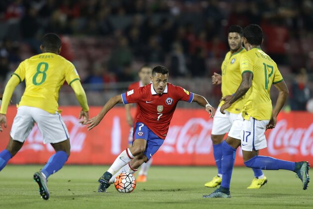 Chile's Alexis Sanchez, center, runs for the ball surrounded by Brazil's Elias, left, and Luiz Gustavo, right, during a 2018 Russia World Cup qualifying soccer match in Santiago, Chile, Thursday, Oct. 8, 2015. (AP Photo/Martin Mejia)