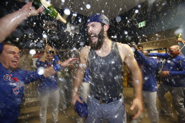 Chicago Cubs starting pitcher Jake Arrieta is sprayed with beer and champagne after pitching a complete game 4-0 win over the Pittsburgh Pirates to win the National League wild card game Wednesday, Oct. 7, 2015 in Pittsburgh. The Cubs advance to face the St. Louis Cardinals in the National League Division Series. (AP Photo/Gene J. Puskar)