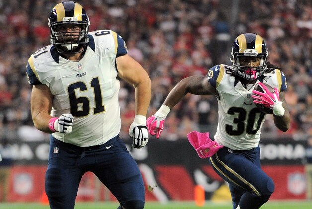 Oct 4, 2015; Glendale, AZ, USA; St. Louis Rams running back Todd Gurley (30) follows the block of center Tim Barnes (61) against the Arizona Cardinals during the first half at University of Phoenix Stadium. The Rams won 24-22. Mandatory Credit: Joe Camporeale-USA TODAY Sports