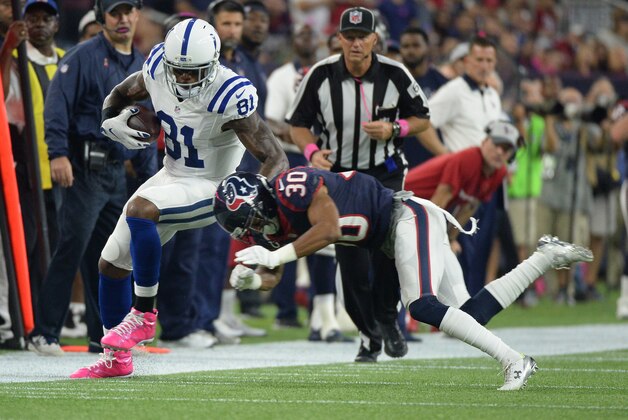 Indianapolis Colts' Andre Johnson (81) is upended by Houston Texans' Kevin Johnson (30) during the first half of an NFL football game Thursday, Oct. 8, 2015, in Houston. (AP Photo/George Bridges)